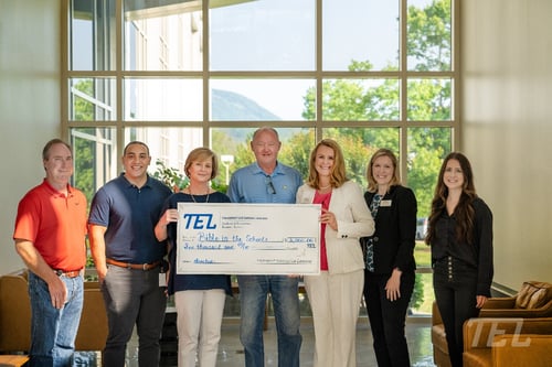 Image shows the team at Transport Enterprise Leasing presenting a donation check for six thousand dollars to Bible In The Schools