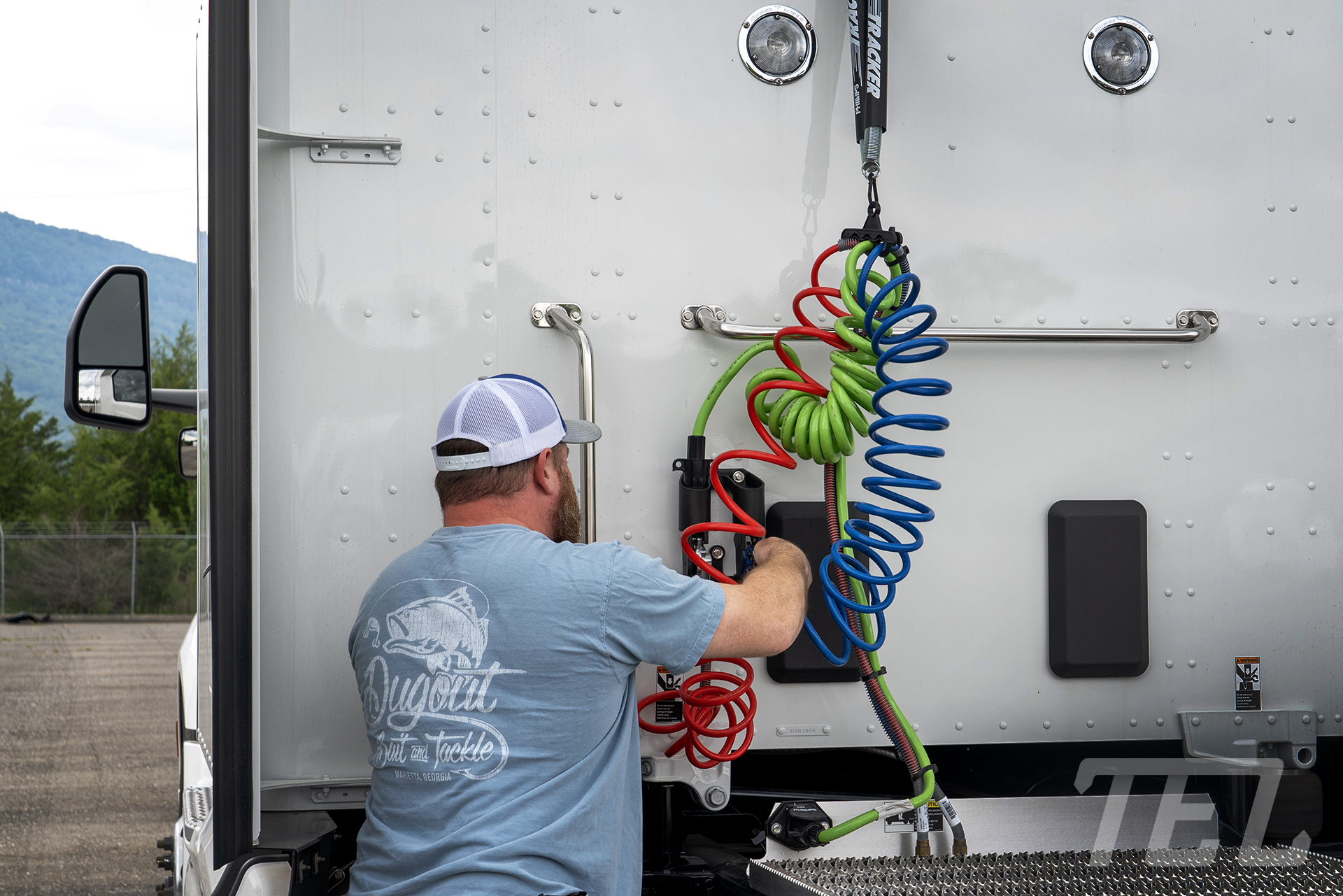 Driver checking the air lines for cracks, breaks, and kinks