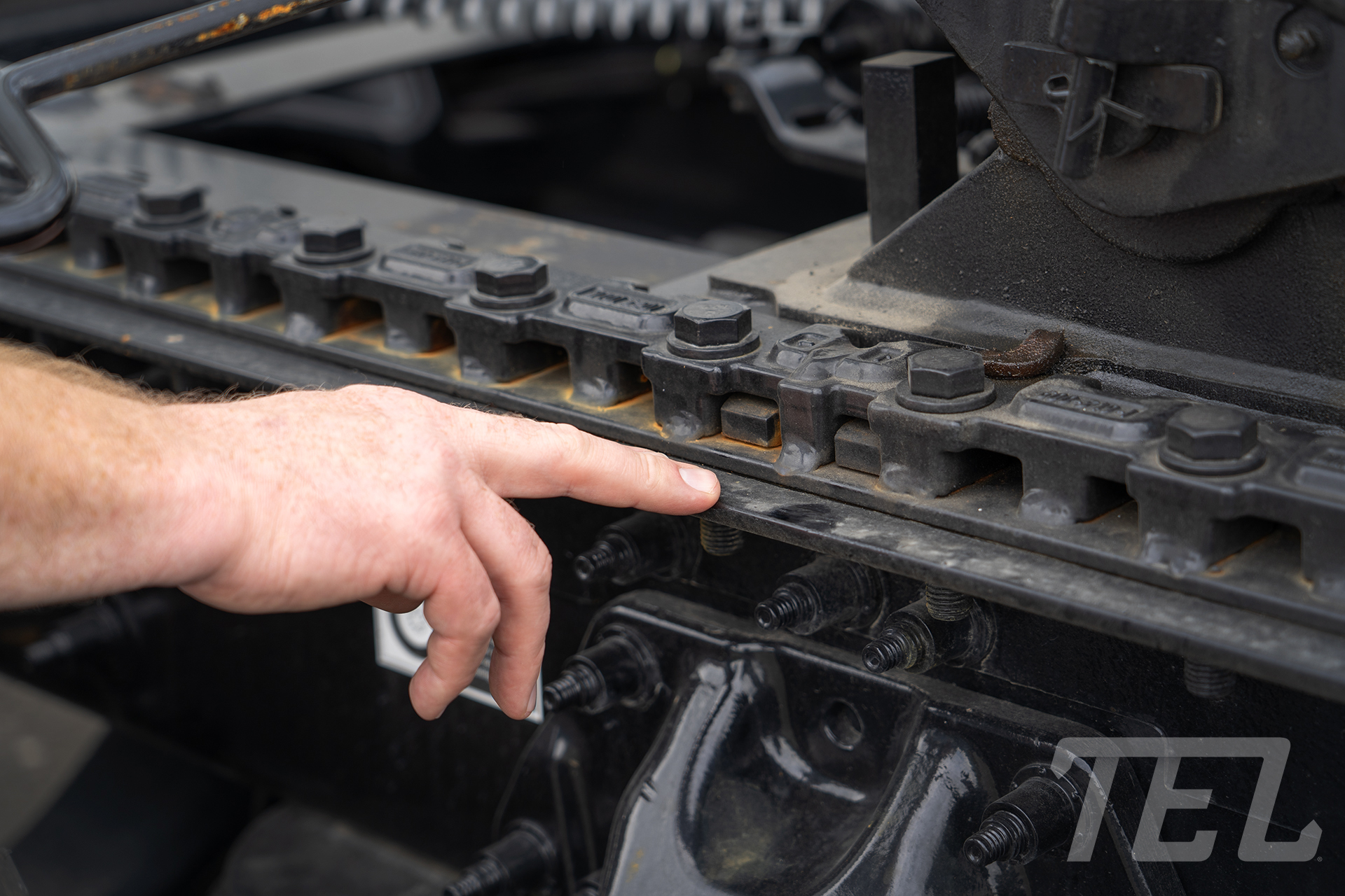 Checking the mounting bolts for cracks or damage on the 5th wheel plate